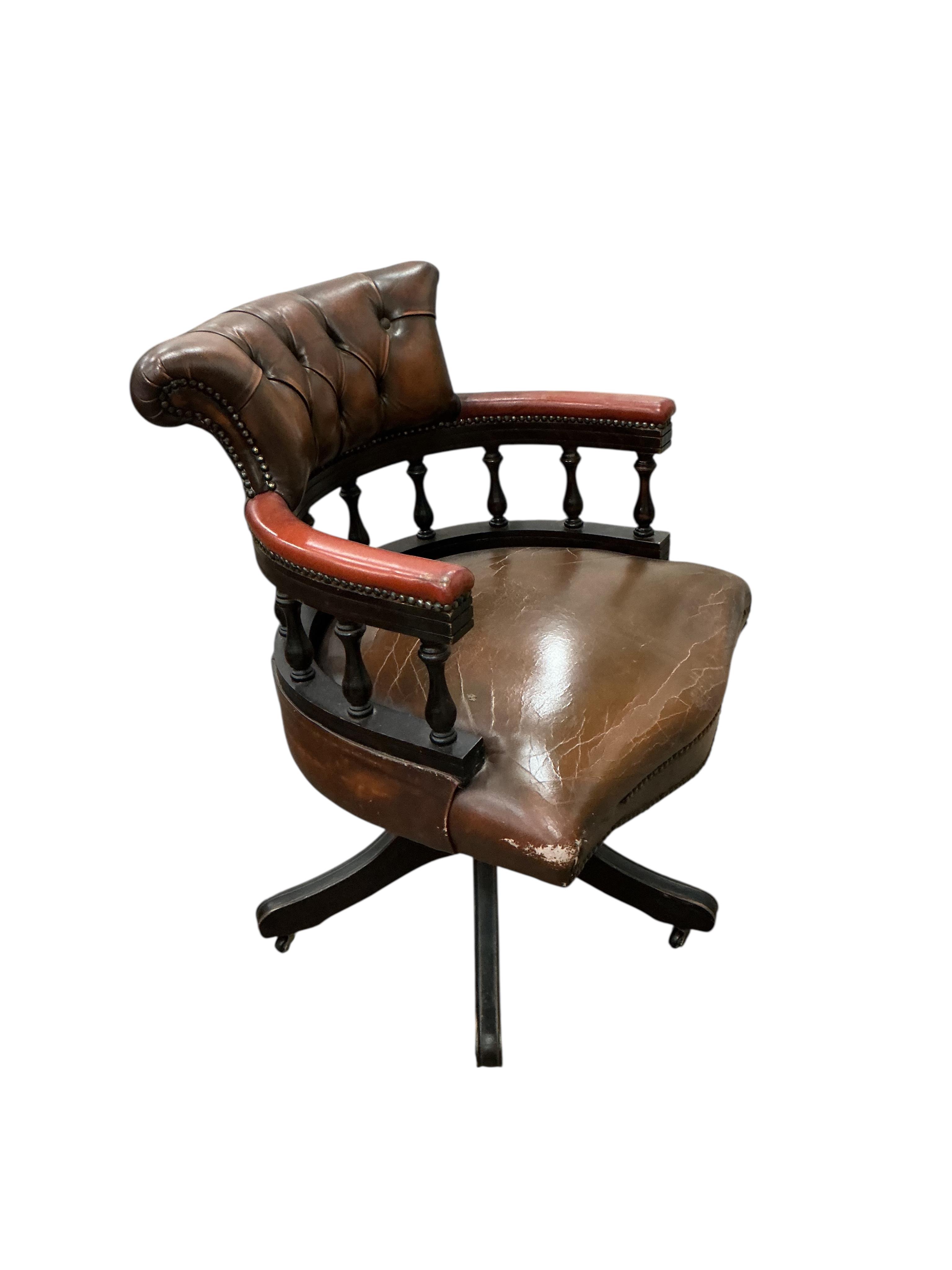 A reproduction yew pedestal desk, width 132cm, depth 61cm, height 77cm and a buttoned burgundy leather swivel desk chair